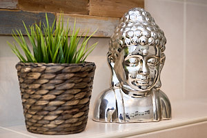 Buddafigur und Pflanze im Badezimmer